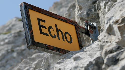 A rustic looking sign reads "Echo" in black letters on a yellow background. The sign is attached to a stone mountain.