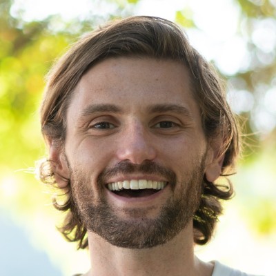A photo of Peter Fitzpatrick, co-founder of Fawn Friends. Peter has light brown hair and a short beard and is smiling at the camera in this headshot.